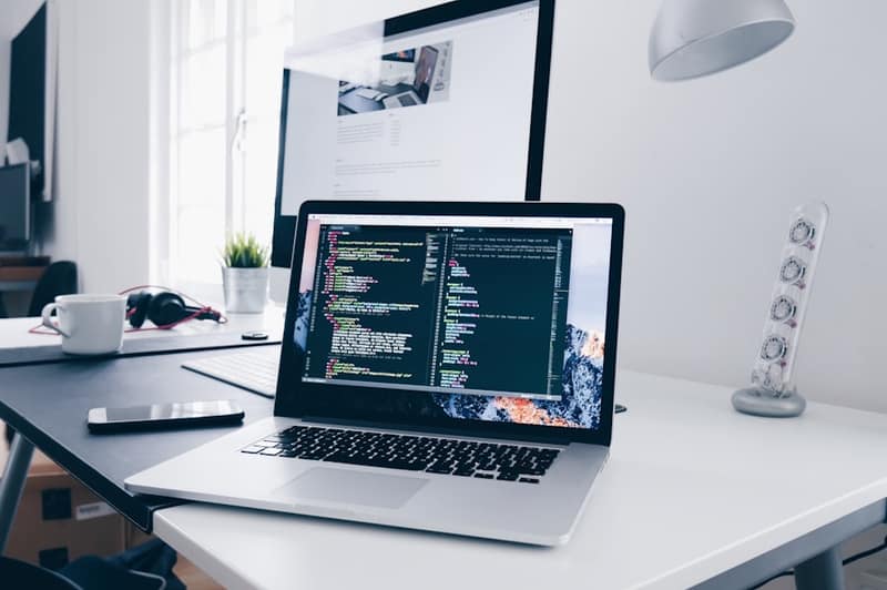 Web development workspace with code on screen